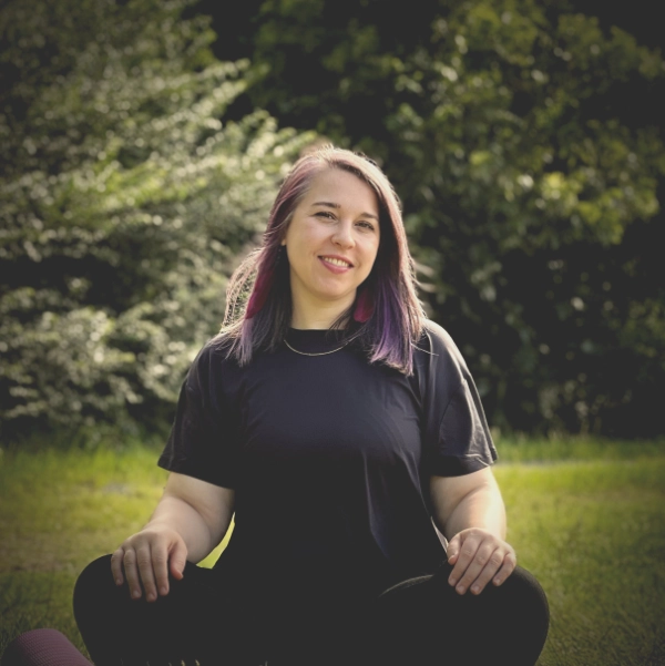 Village Yogi’s instructor seated in quiet practice outdoors